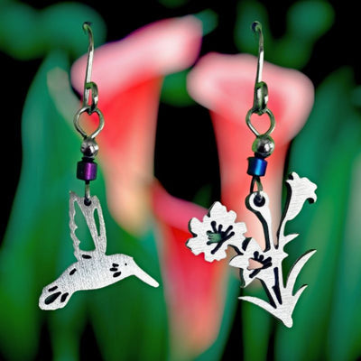 This pair of Hummingbird and Flowers Stainless Steel Earrings has a hummingbird on one earring and flowers on the other.