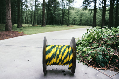 Hunter Green and Yellow Solid Braided Multifilament Polypropylene Rope in the yard