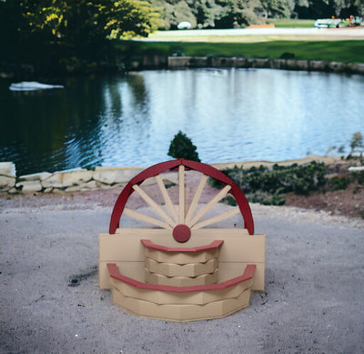 Clay with Red Amish Made Poly Wagon Wheel Planter by the pond