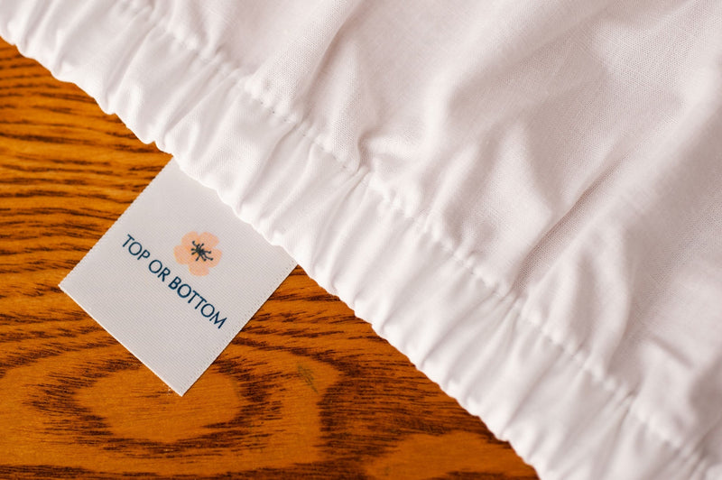 White Fitted US grown cotton Bed Sheet showing American Blossom Linens "Top or Bottom" tag.