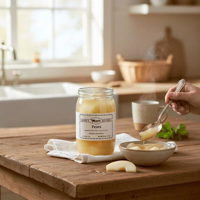 Annie’s Kitchen Pears served in a bowl with sliced pears in a warm, rustic kitchen setting.