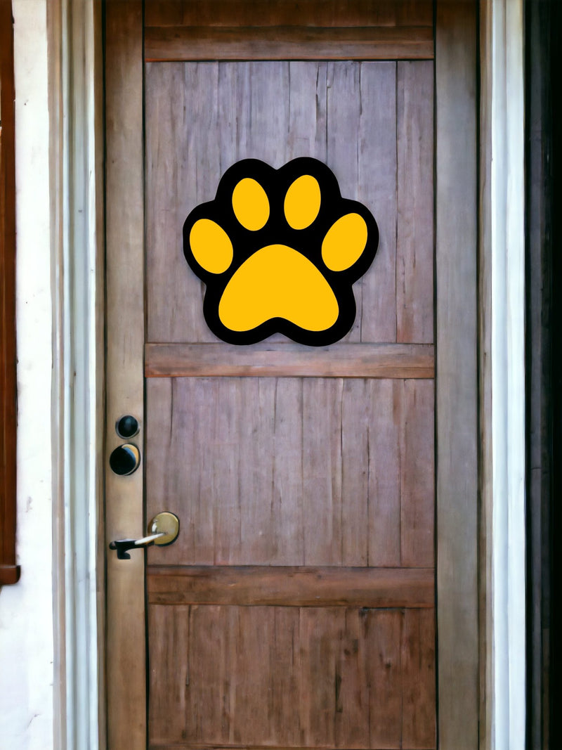 Black/Yellow Wooden Paw Print Door Hanger on a dark wooden front door.