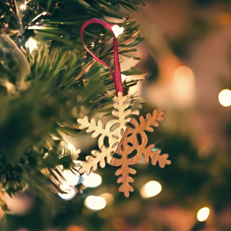 Two different types of wood are used to create each beautiful snowflake ornament.