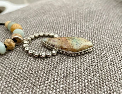 Side view of the Handmade Confetti Chrysocolla and Sterling Silver Pendant 