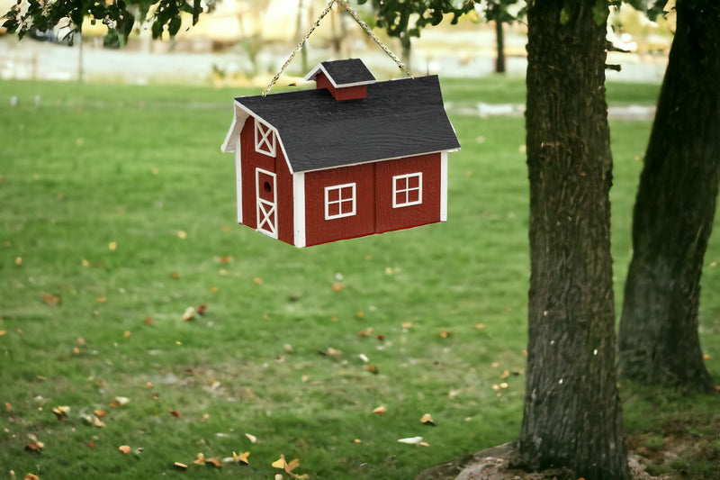 Red Barn Wooden Birdhouse hanging from a tree branch
