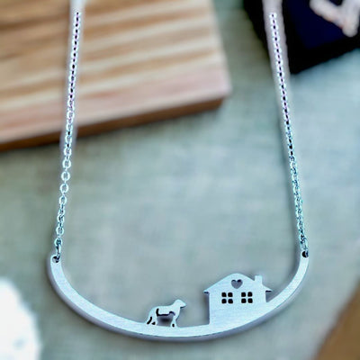 Look closely at the dog in this Dog and House Stainless Steel Necklace. Great gift for any pet lover