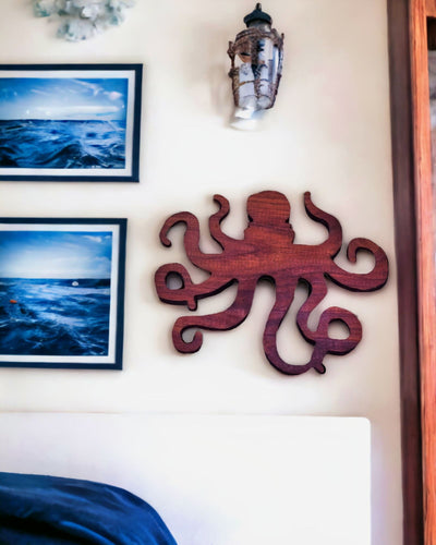 Wooden Octopus Figurine - 7.5 x 6 Inches hung on an ocean themed bedroom wall.