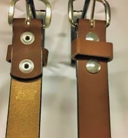 Close up of Gun Metal Gray Snaps and Buckle on a Golden Brown Leather Belt.