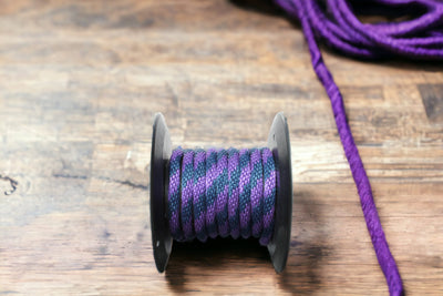 Purple and Navy Solid Braided Multifilament Polypropylene Rope on the floor