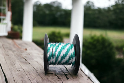 Teal and White Solid Braided Multifilament Polypropylene Rope on the porch
