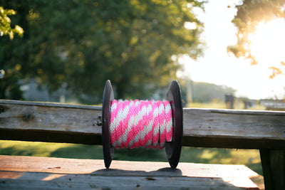 Hot Pink and White Solid Braided Multifilament Polypropylene Rope on a table