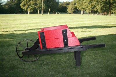Red and Black Amish Made Decorative Poly Wheelbarrow in the yard