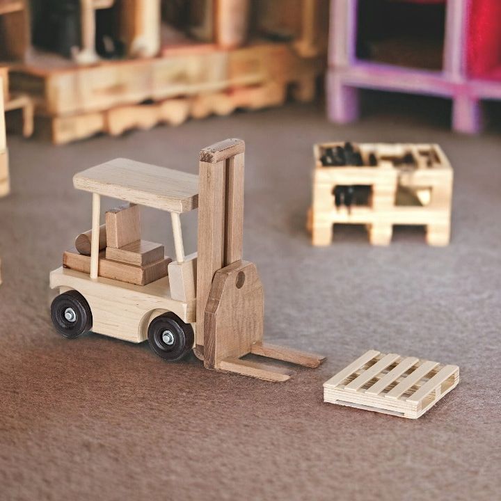 Wooden Toy Forklift with 1 Pallet in playroom.
