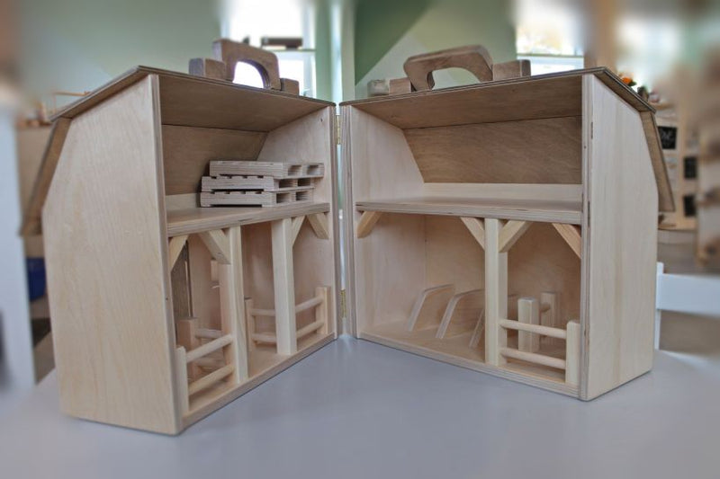 Folding Wooden Barn Toy at Harvest Array, shown open to see inside stalls.
