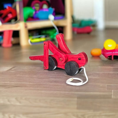  Red Wooden Grasshopper Pull Toy shown in a playroom
