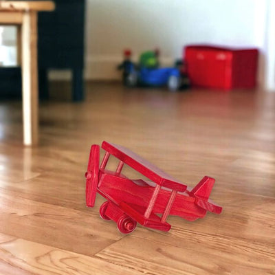 Amish Made Red Small Wooden Airplane in the playroom.