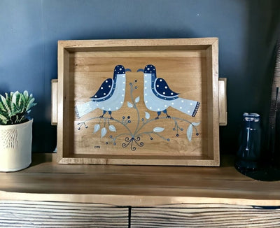 Two White Polka Dotted Blue Birds Handmade Wooden Folk Art Tray upright on a dining room hutch .