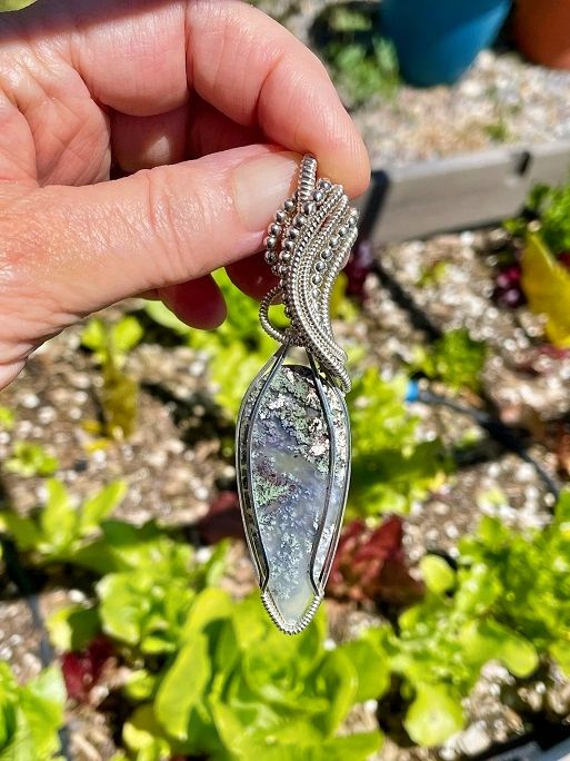 The Natural Moss Agate Gemstone is artistically wrapped in .925 Sterling Silver wire with SS beads