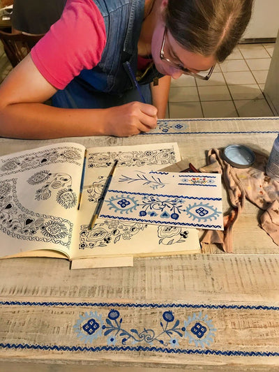 This is the Artist at My Natural Playce that hand painted each adapted design onto the maple wood square. 