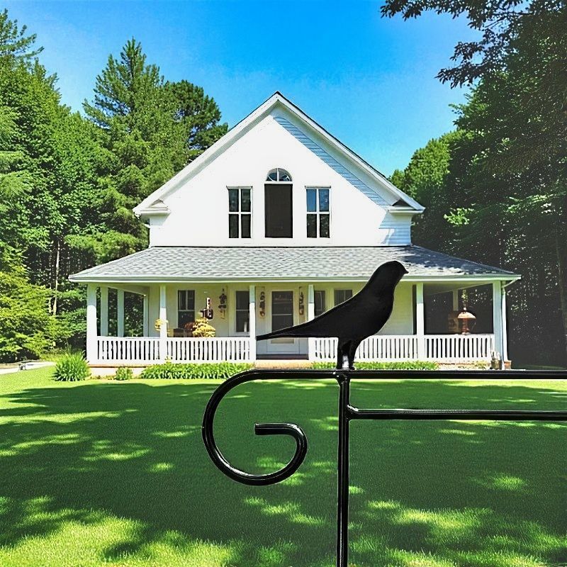 Metal Garden Flag Holder with Decorative Bird Emblem on top.