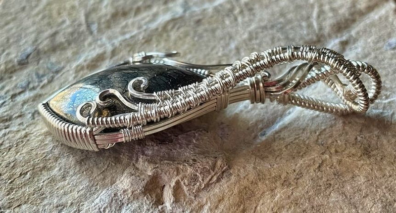The Sterling Silver Wire is artistically wrapped to form a sturdy bale so the necklace will not detach from the pendant as seen in this side view of the pendant..