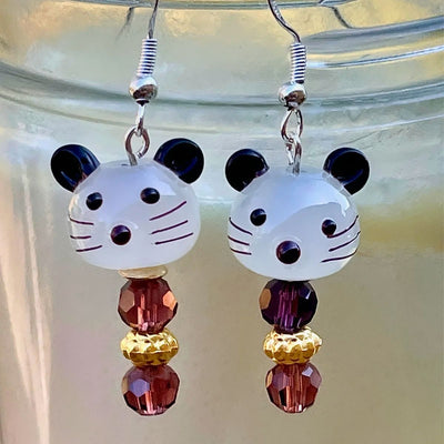 Mouse Face Lamp Work Glass Bead Earrings with purple accent beads.