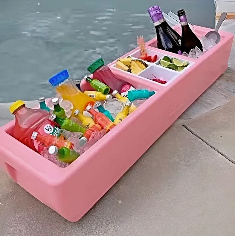 Pink Coral Party Barge sitting on the edge of a swimming pool.