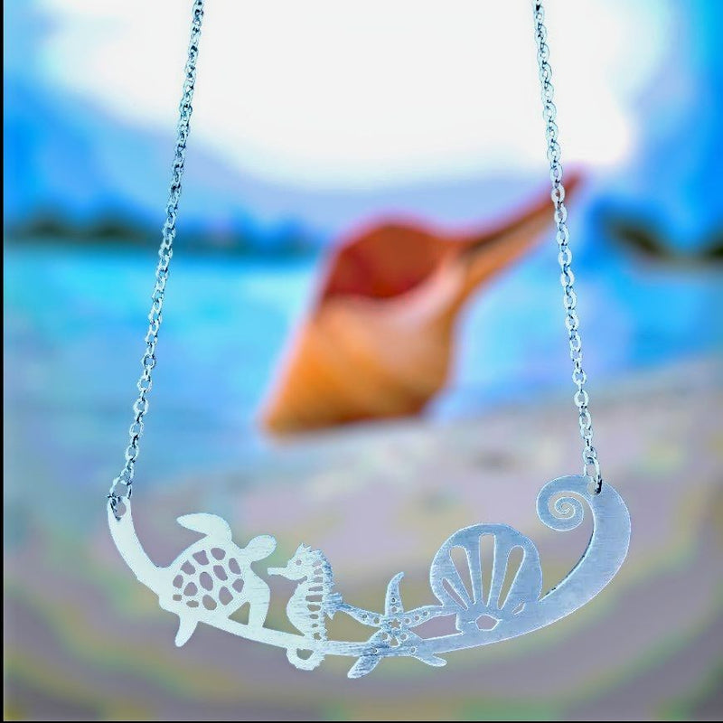 This Stainless Steel Necklace on Harvest Array has a sea turtle, sea horse, star fish, and a shell design . Makes a great gift for any beach or ocean lover. 