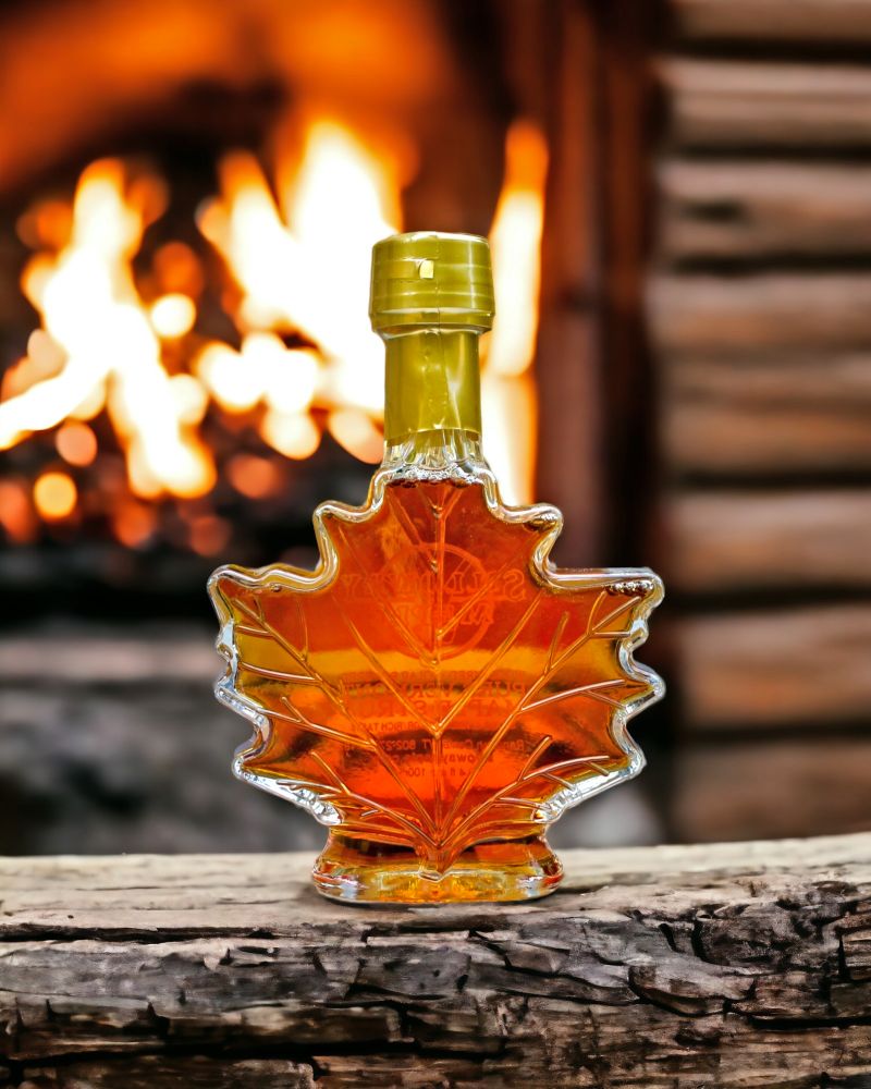 Beautiful amber color of Pure Vermont Maple Syrup as seen through the back of an 8.5 Ounce Glass Leaf Jar. Purchase a bottle online at harvestarray.com.