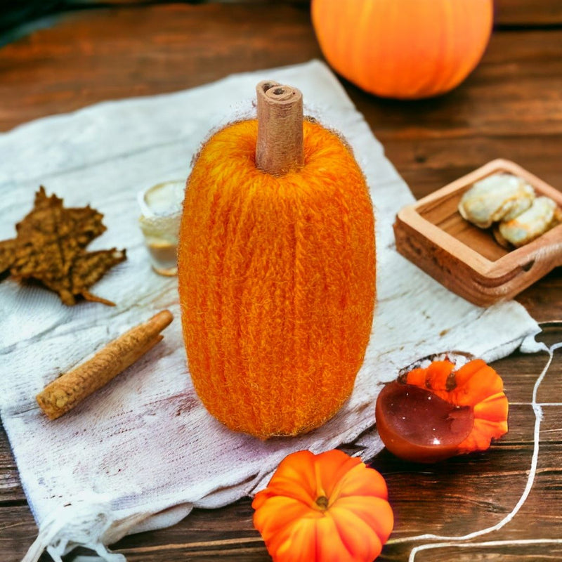Decorate for fall with our Small Orange Yarn Pumpkin with Cinnamon Stick Stem.