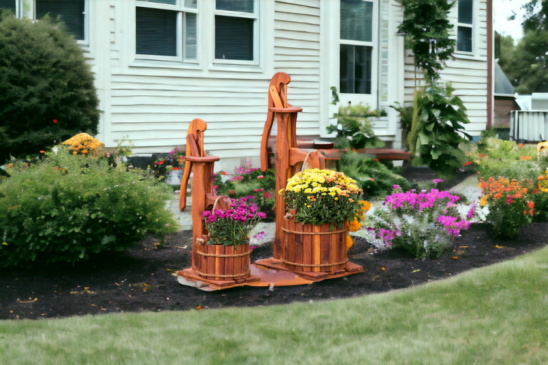Two sizes of the Amish Made Cedar Water Pump Planters in the yard