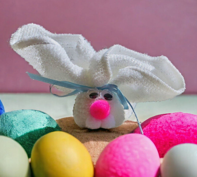 Adorable white washcloth bunny with googly eyes and a pink nose. 