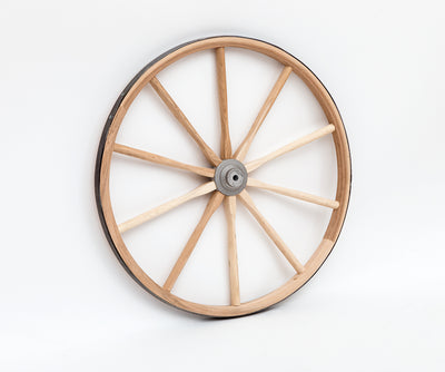 Single light duty wooden cart wheel against a white background