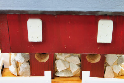 Close up view of the bird entrance of the Amish Made Red Barn Birdhouse from Harvest Array 