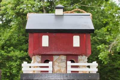 Close up view of the Amish Made Red Barn Birdhouse from Harvest Array