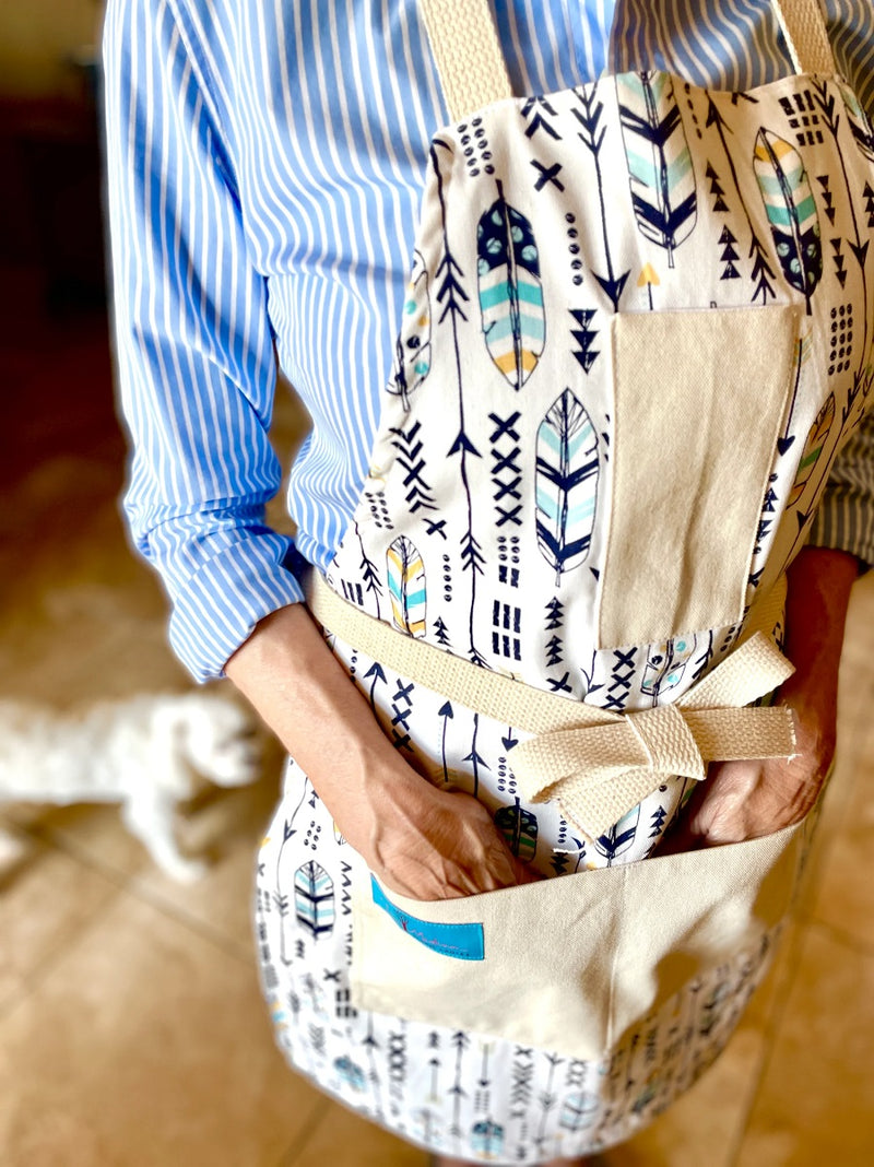 Candace Arrows and Feathers Print Apron with the pockets in use
