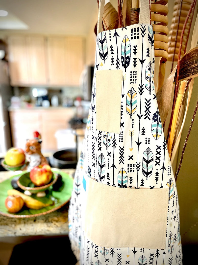 Candace Arrows and Feathers Print Apron hanging up