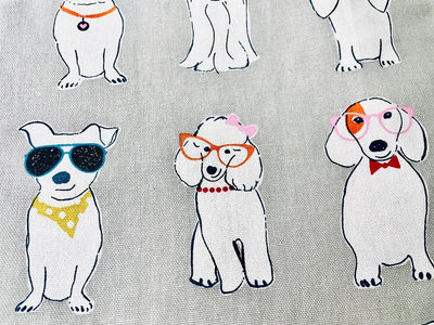 Material for the Coco White Dog Print Apron