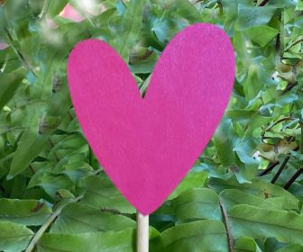 Handwritten Heart Garden Stake outside in garden.