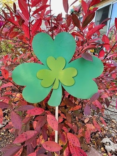 Shamrock Duo Garden Stake shown near a tree