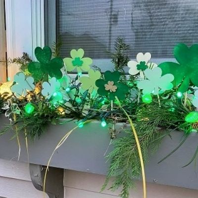 Window box display of assorted colors of Mini Shamrock Duo Plant Stakes. .