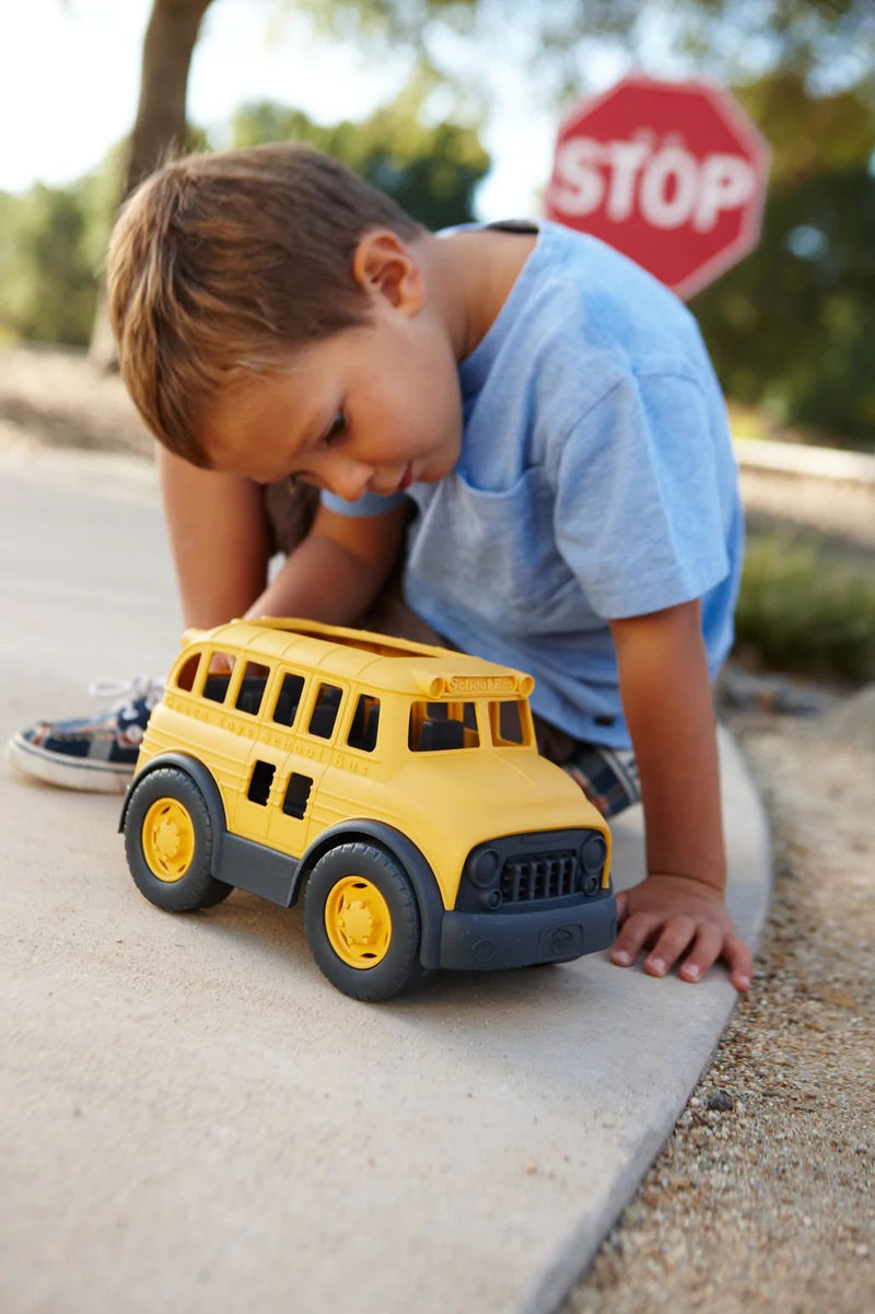 Child looking at School Bus 100% Recycled Plastic Toy