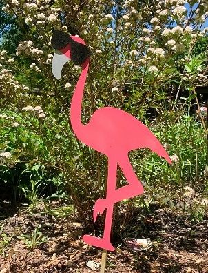 Groovy Flamingo Jumbo Wooden Garden Stake with Shimmer Finish outside in yard.