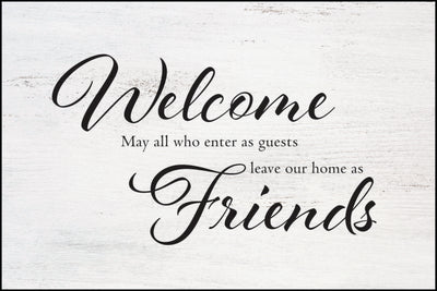 "Welcome May all who enter as guests leave our home as Friends" on white wooden like background.