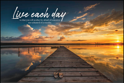 "Live each day so that you will neither be afraid of tomorrow nor ashamed of yesterday." with wooden dock with small boat at the end and a pair of flip flops on it. Reflective sunset on the lake as the background of this plaque.