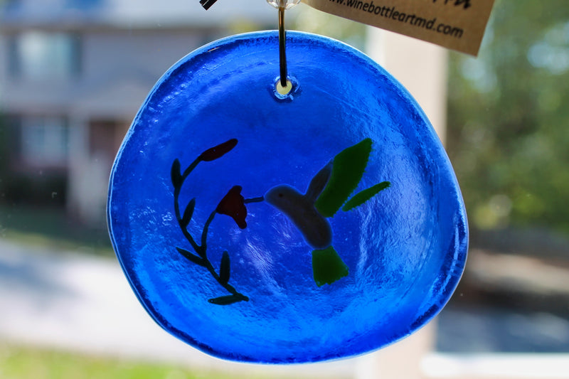 Hummingbird on blue glass