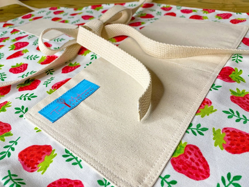 Close up of the Maggie Strawberry Print Apron