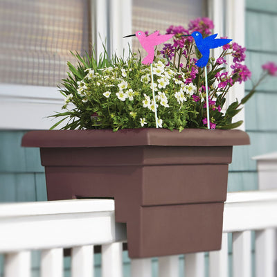 Two Hummingbird Petite Plant Stakes in an over-the-railing flower planter.