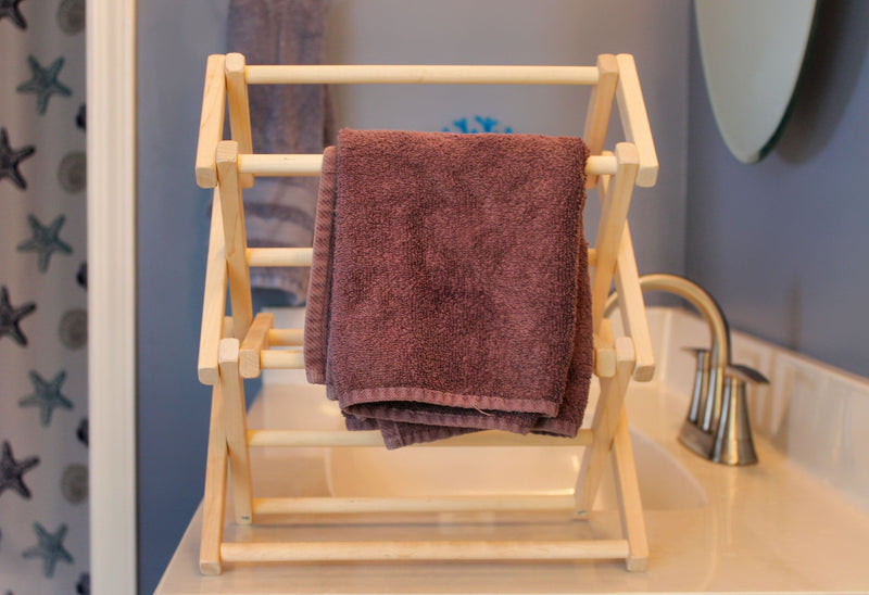 Organize your kitchen with our decorative wooden drying rack. Perfect for holding hand towels, dish towels, and more.