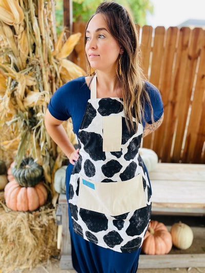 Susanna Cow Print Apron being worn